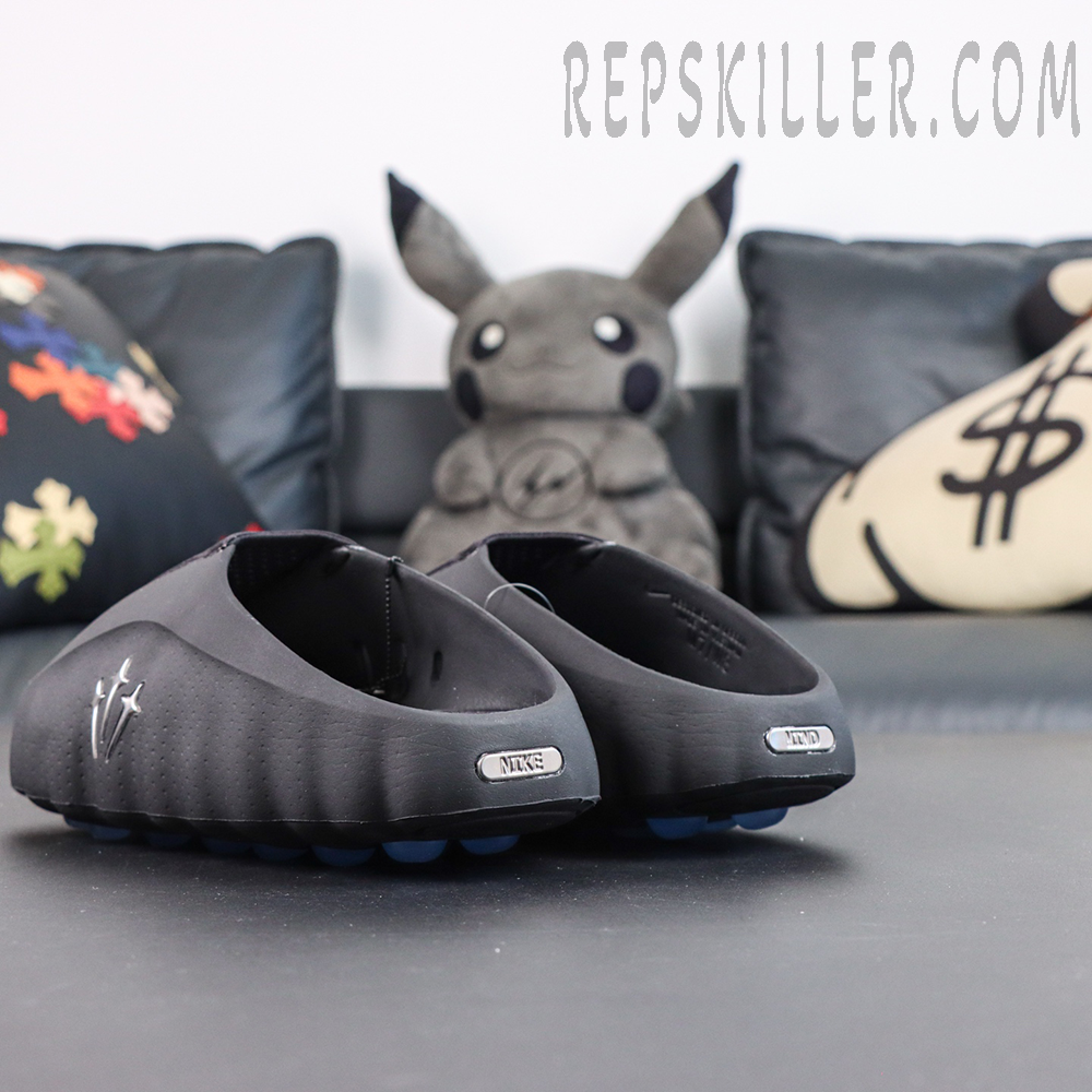 Drake NOCTA x Nike Mind 001 ‘Black’ rear view featuring metallic Nike and MIND heel badges that highlight the collaborative design details