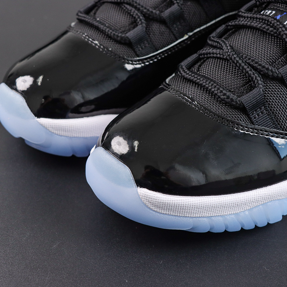 Jordan 11 Retro ‘Space Jam’ toe box detail featuring glossy patent leather and signature lacing system