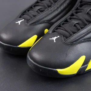 Jordan 14 Retro ‘Thunder’ toe detail featuring a black upper, white Jumpman logo, and vibrant yellow accents