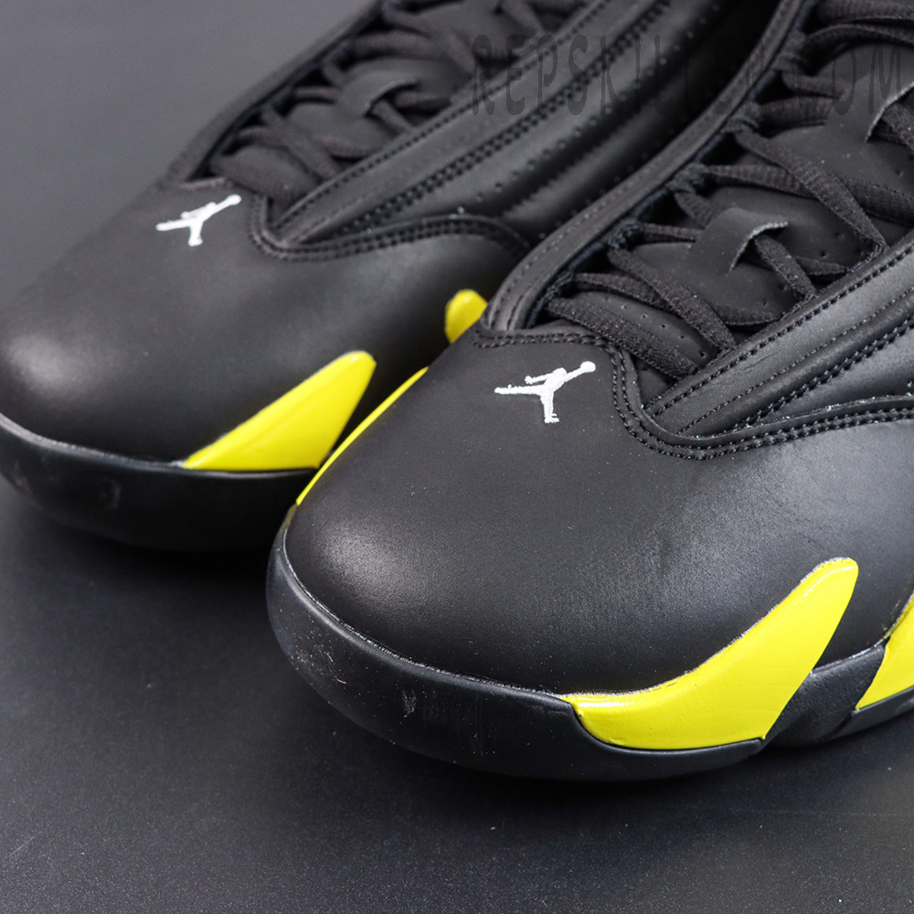 Jordan 14 Retro ‘Thunder’ toe detail featuring a black upper, white Jumpman logo, and vibrant yellow accents