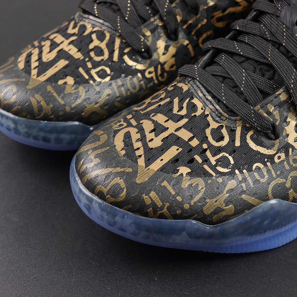 Kobe 11 Protro Low ‘Mamba Day’ upper detail featuring black base with metallic gold numbers and tribute graphics