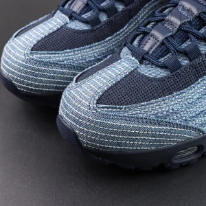 Levi’s x Air Max 95 OG “Obsidian” toe box detail featuring layered blue denim with white contrast stitching and navy mesh for a classic denim look