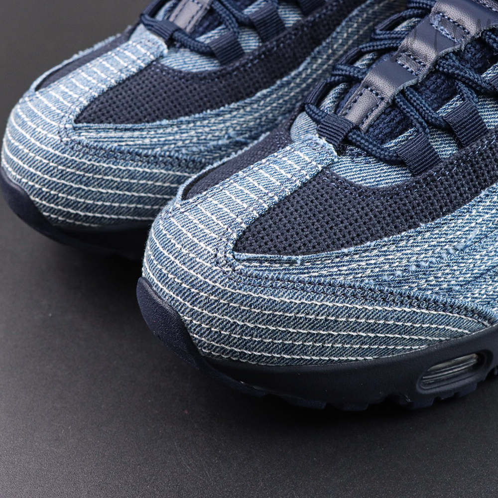 Levi’s x Air Max 95 OG “Obsidian” toe box detail featuring layered blue denim with white contrast stitching and navy mesh for a classic denim look